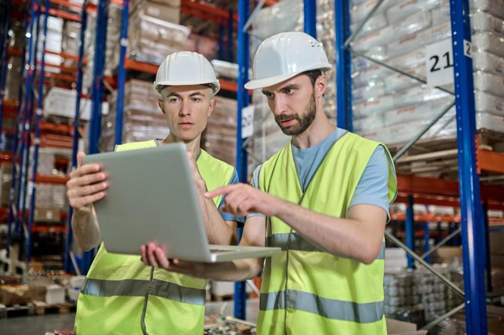 5s-methodology-in-maintenancetwo men looking laptop deciding work question warehouse