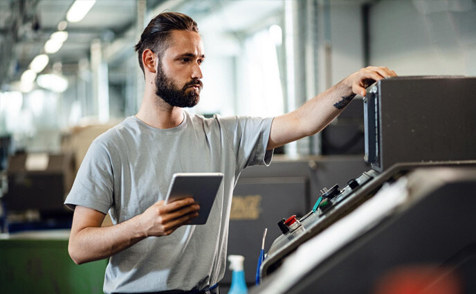 CMMS IOT integration maintenance management man technician inspecting equipment