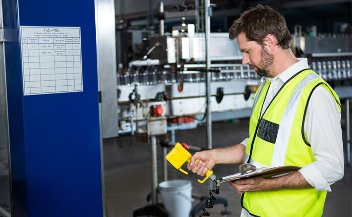 CMMS IoT integration challenges man using iot device in factory