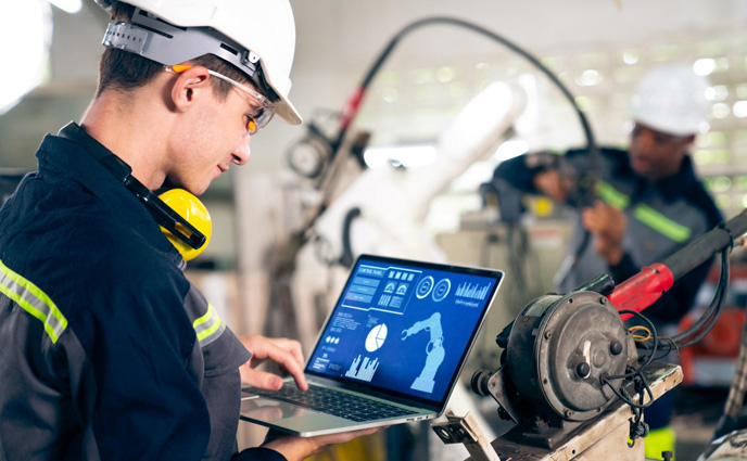 ai cmms software young factory worker working with adept robotic arm
