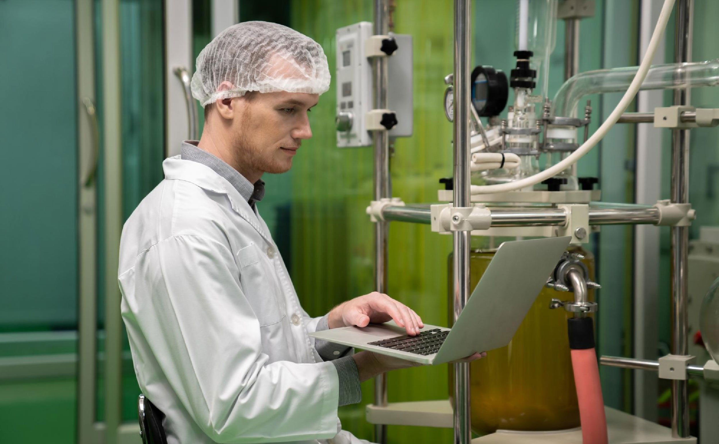 cmms obsolescence management scientist recording data from oil extractor laboratory
