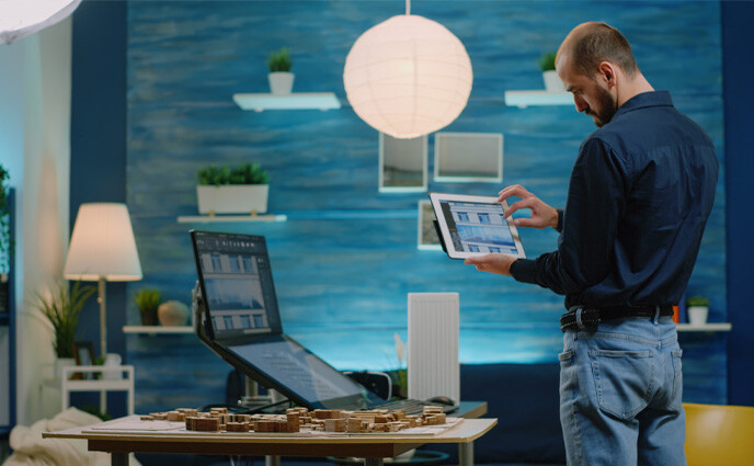 cmms iot industry use cases man checking data from iot sensors on laptop