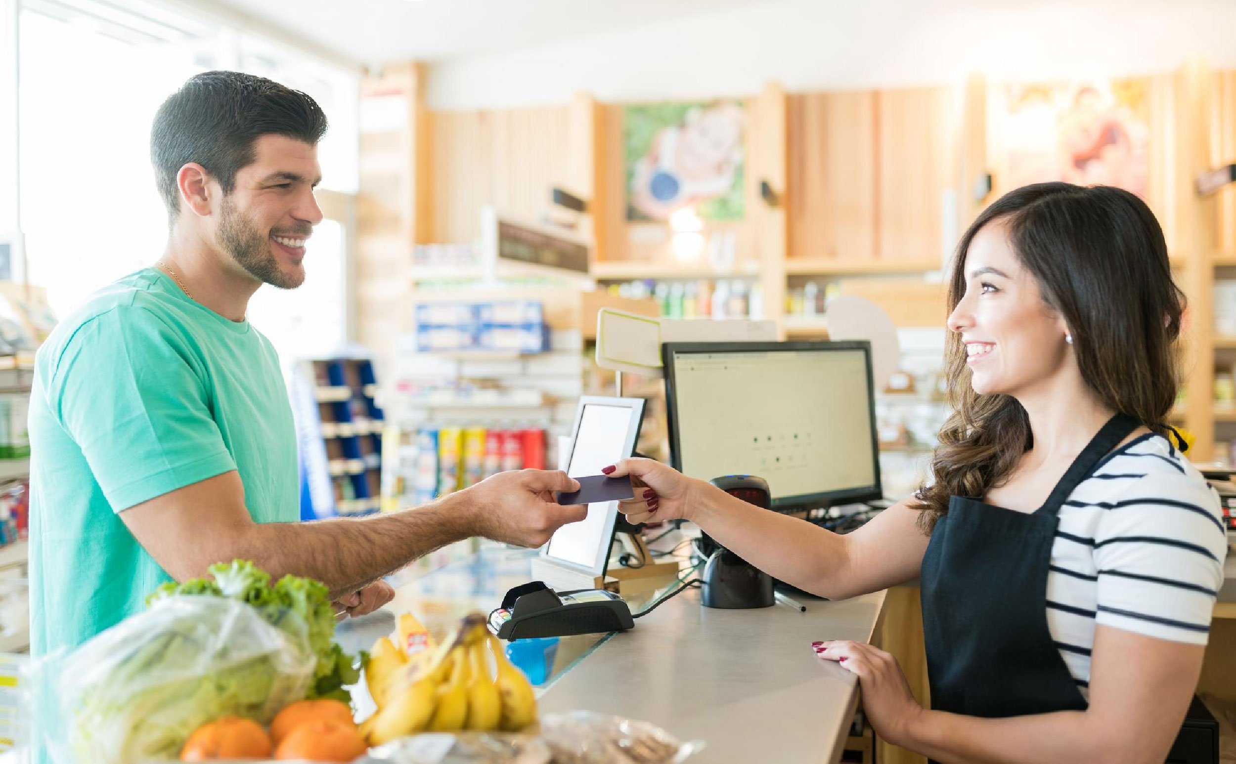 cmms competitive advantage smiling female cashier with buyer checkout counter grocery store
