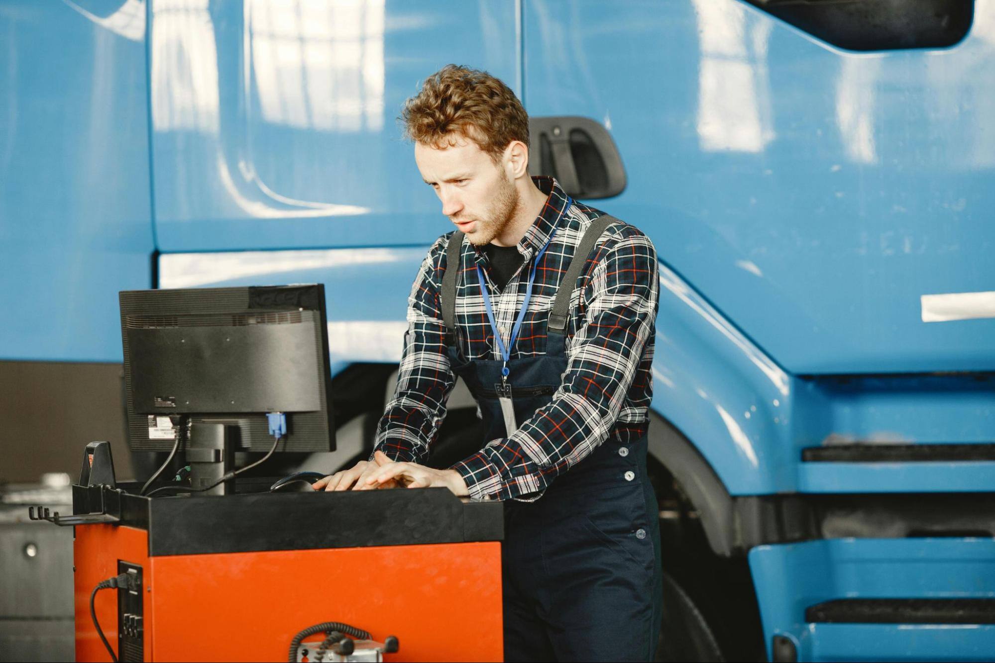 cmms data insights factory worker working on computer