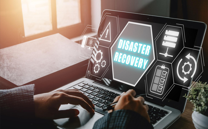 cmms disaster recovery planning person hand using laptop computer with disaster recovery icon virtual screen