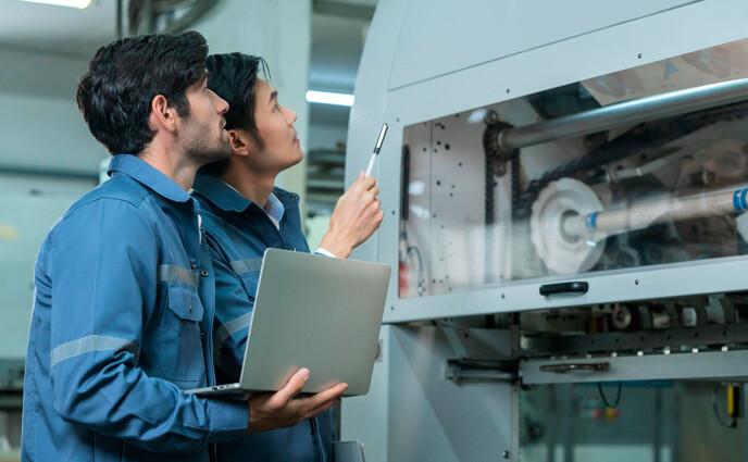 cmms root cause analysis two engineers checking machine