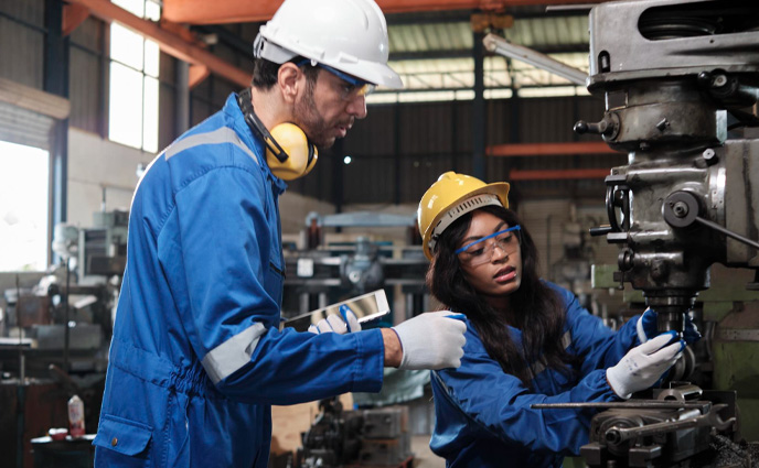 cmms software advantages two industrial workers in manufacturing factory