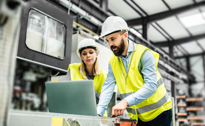cmms software obsolescence industrial man woman engineer with laptop working in factory