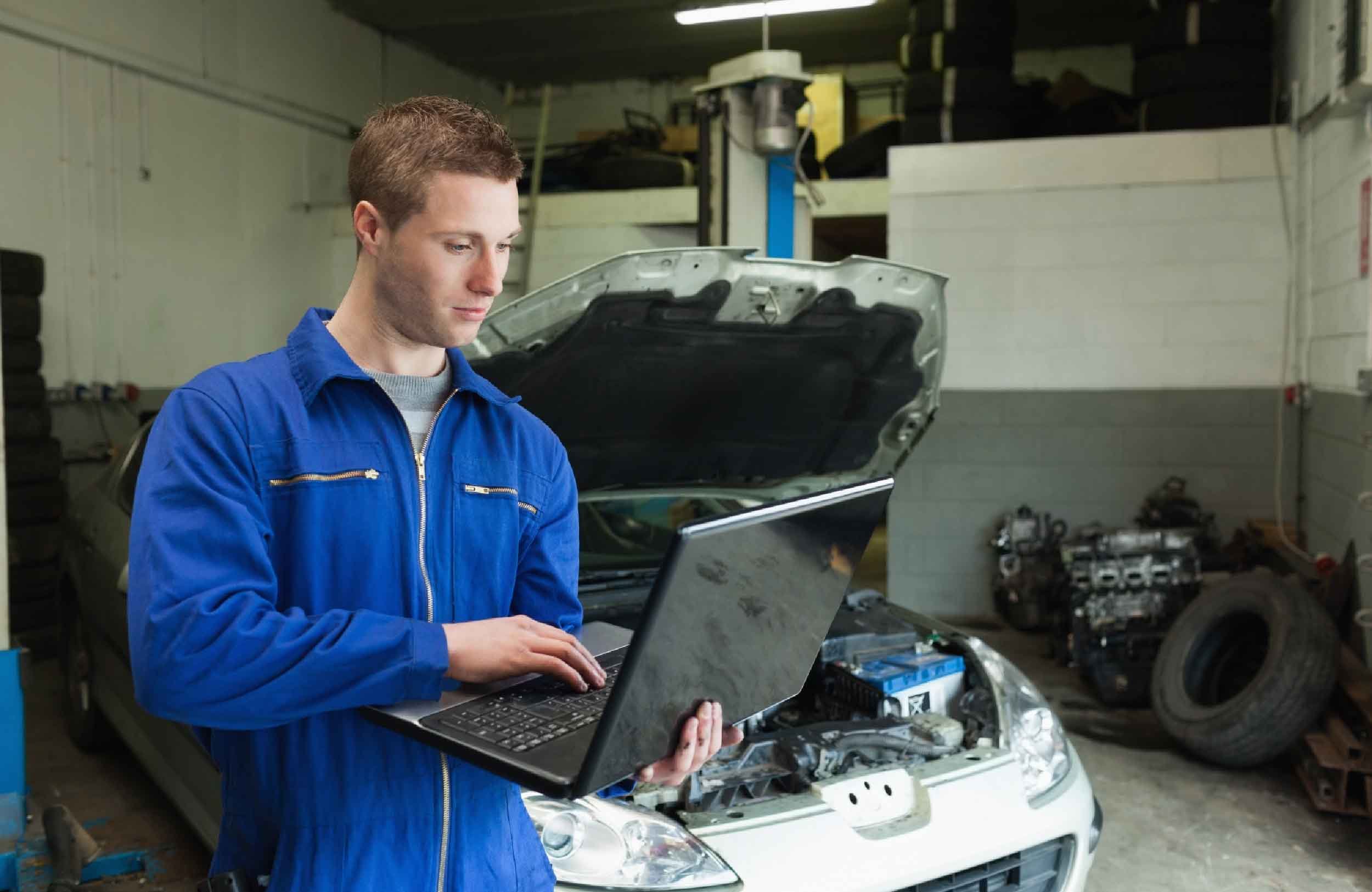 cmms software tax impact mechanic using laptop garage