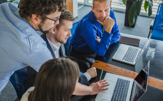cmms training maintenance professionals looking on laptop screen