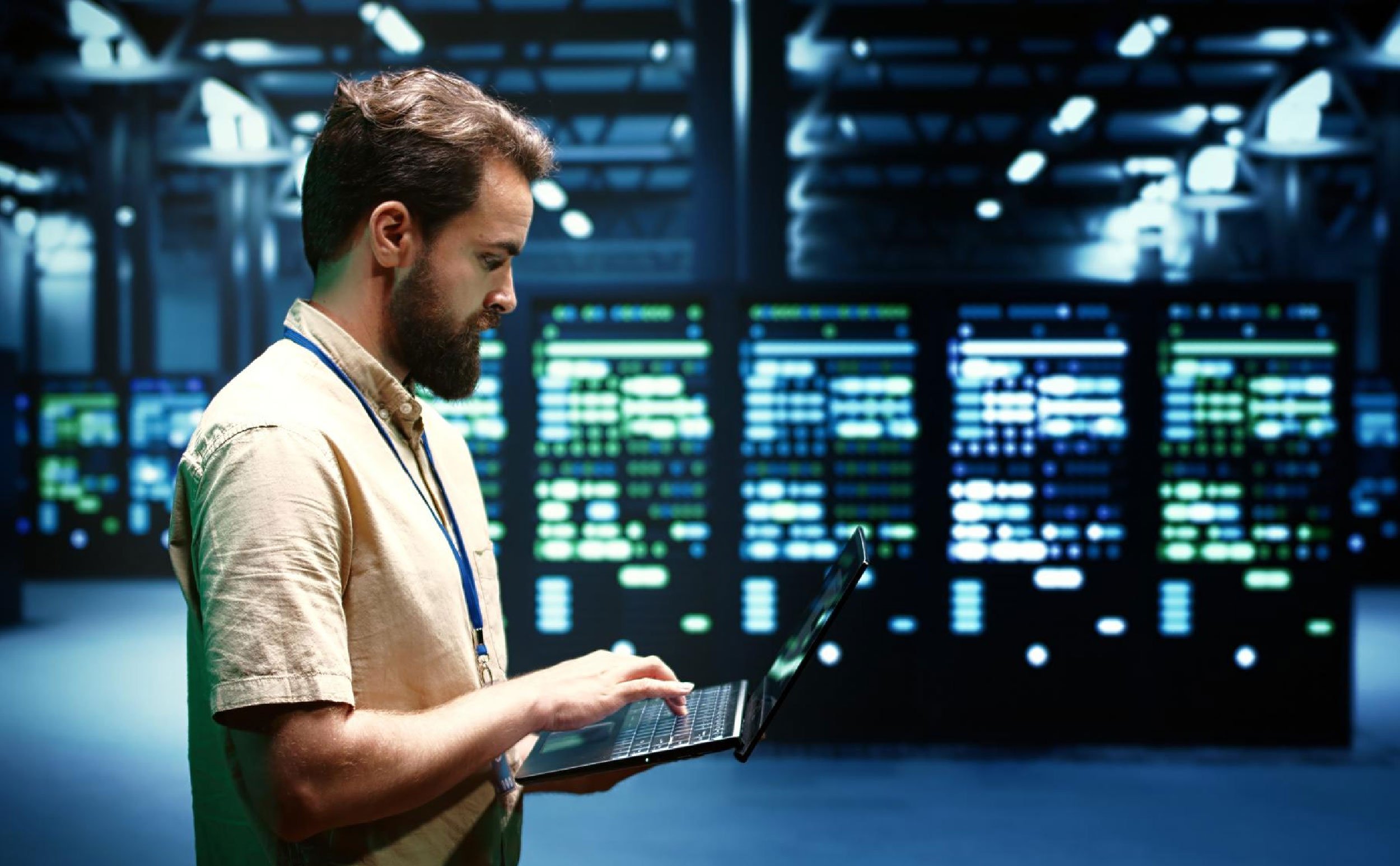 data center cmms man with laptop in data center
