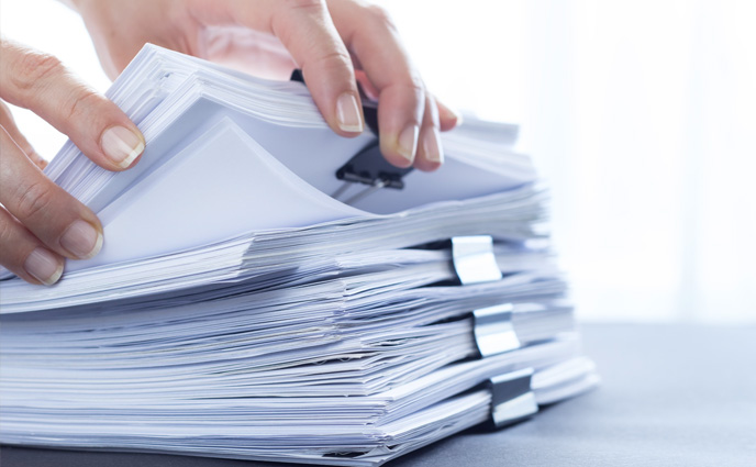 work order software evolution stack of paper