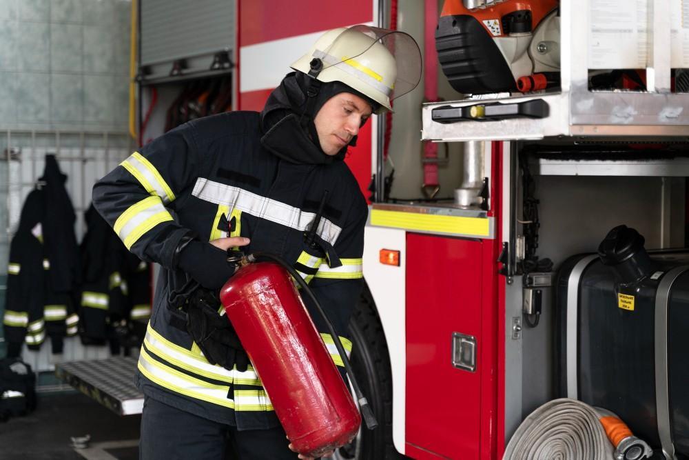 facility fire safety maintenance male firefighter station equipped with suit safety helmet