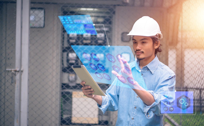 facility maintenance trends 2025 electrician using tablet checking electric system factory plant