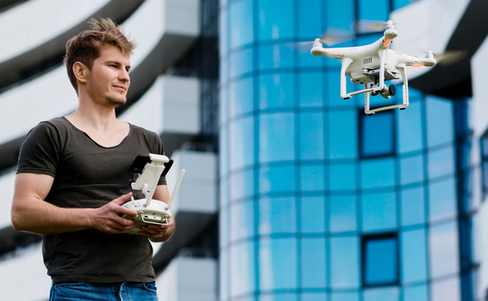 facility maintenance trends 2025 man controls drone outdoors