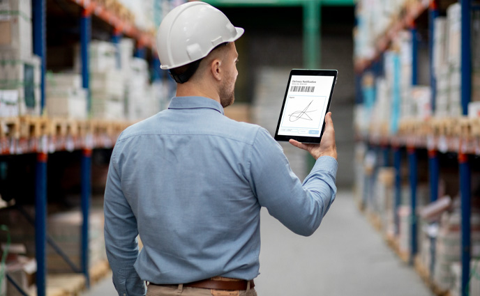fiix cmms vs click maint cmms man checking inventory on tablet in warehouse
