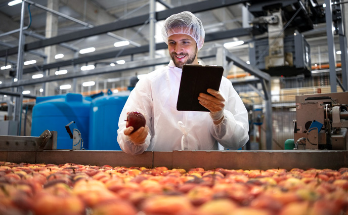 fiix cmms vs click maint cmms technologist doing quality control apple fruit production food processing plant