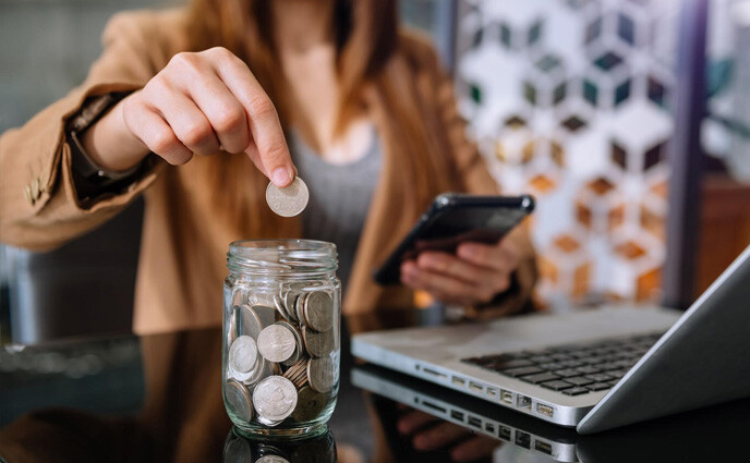 free cmms software hand putting coins in jar