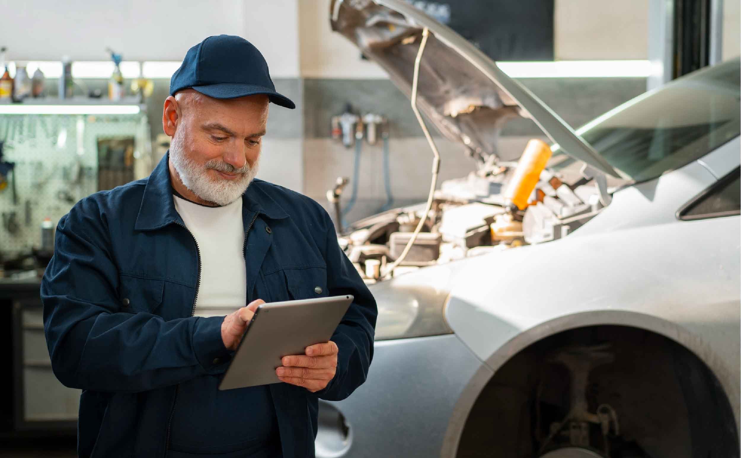 maintenance checklist manifesto male car mechanic using tablet device