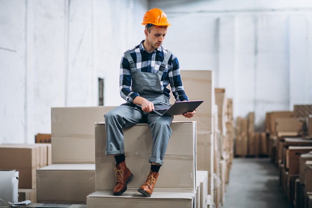 maintenance management overstocking risks young man working warehouse with boxes