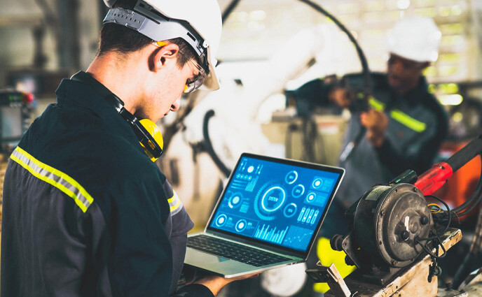 maintenance outcomes male technician looking at analytics on screen