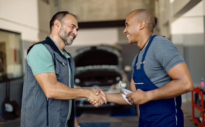 cmms maintenance outsourcing two maintenance professionals shaking hands