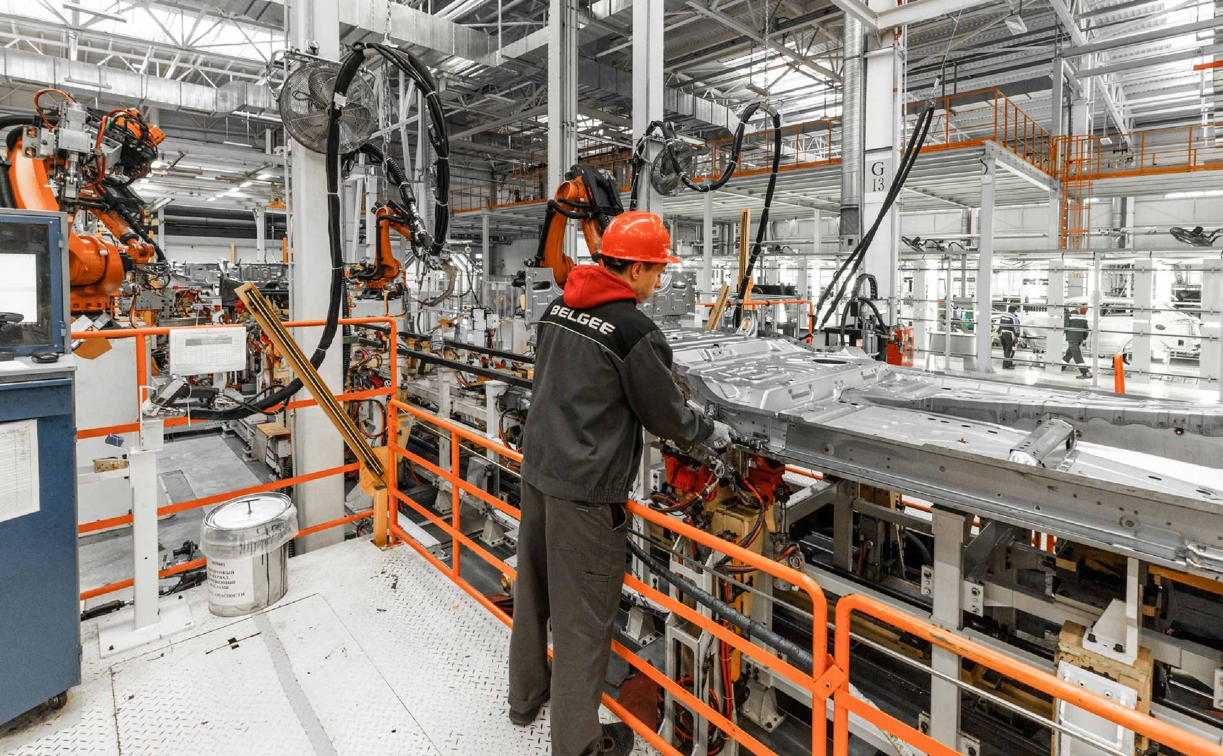 manufacturing downtime fixes male worker automobile production line