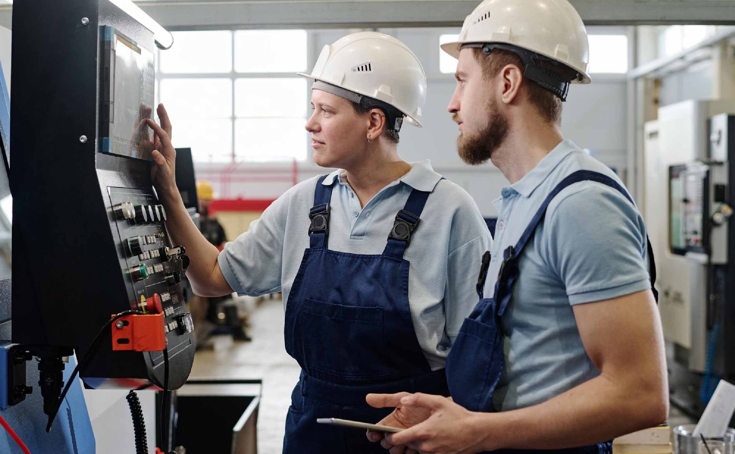 objective based maintenance 101 two specialists operating cnc machine