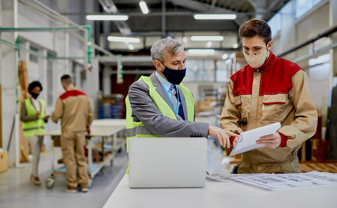 pf curve id adult engineer male worker wearing face masks while examining paperwork