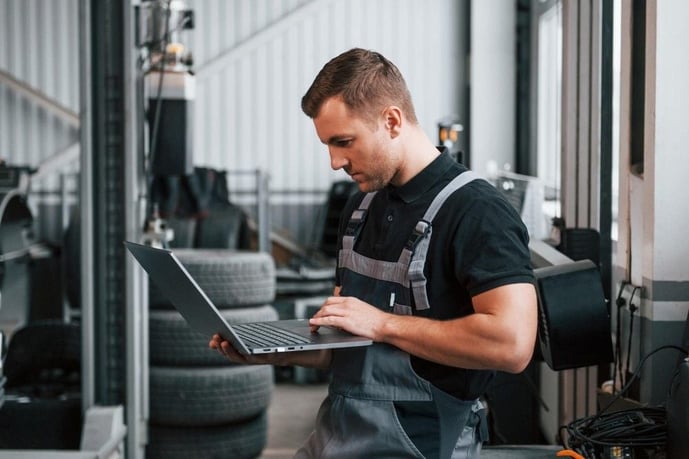 preventive maintenance vs reactive maintenance technician using laptop at work