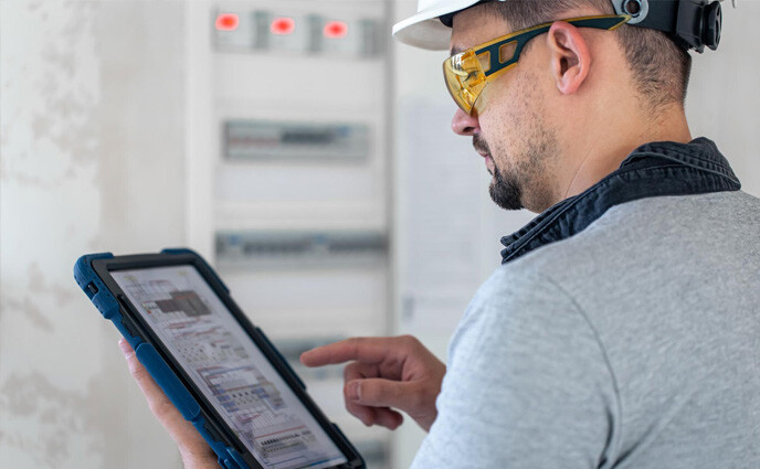 preventive-maintenance-software-technician-looking-on-tablet-screen