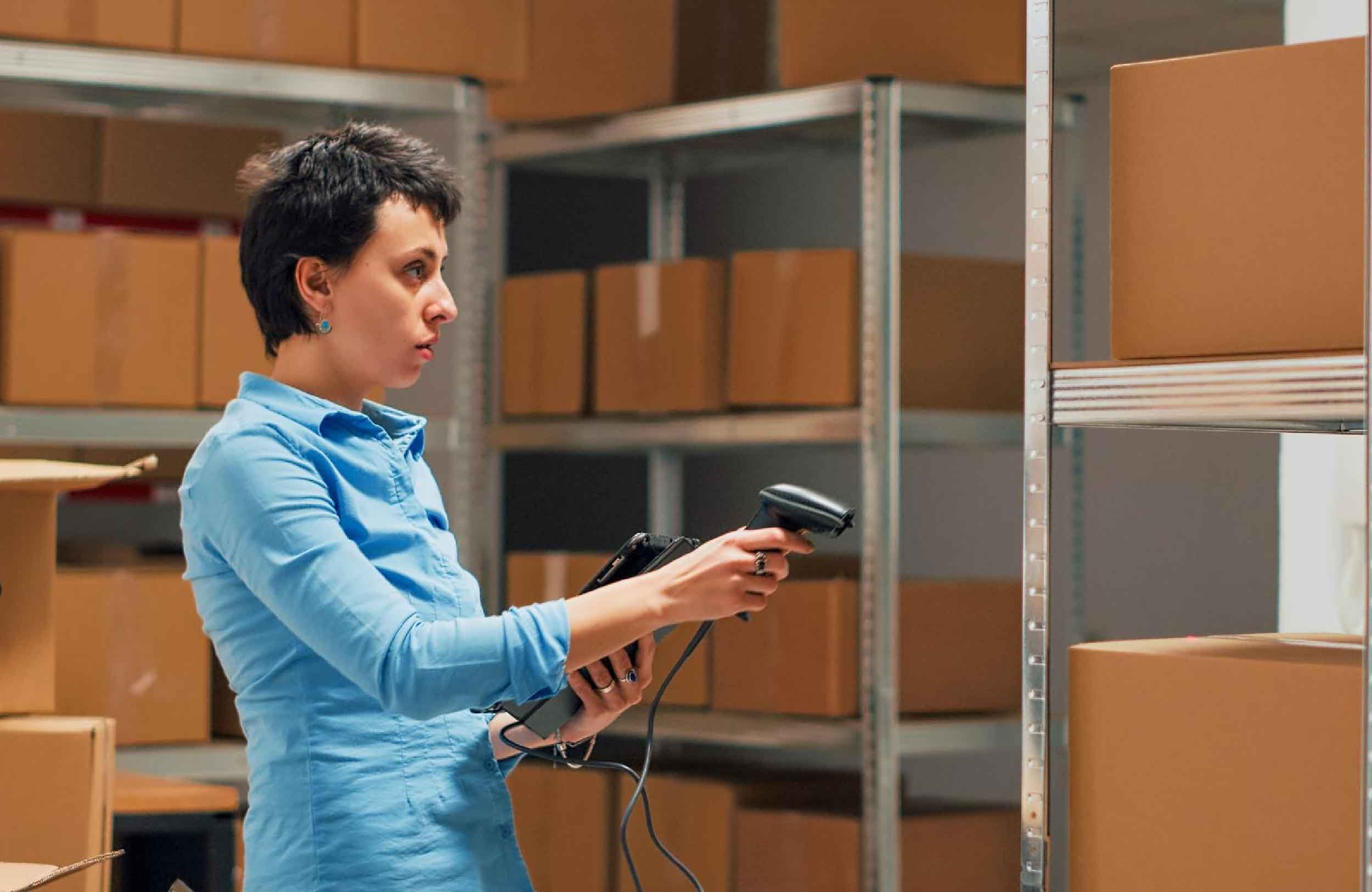 spare parts warehouse management female employee using tablet scan bar code merchandise handheld shot