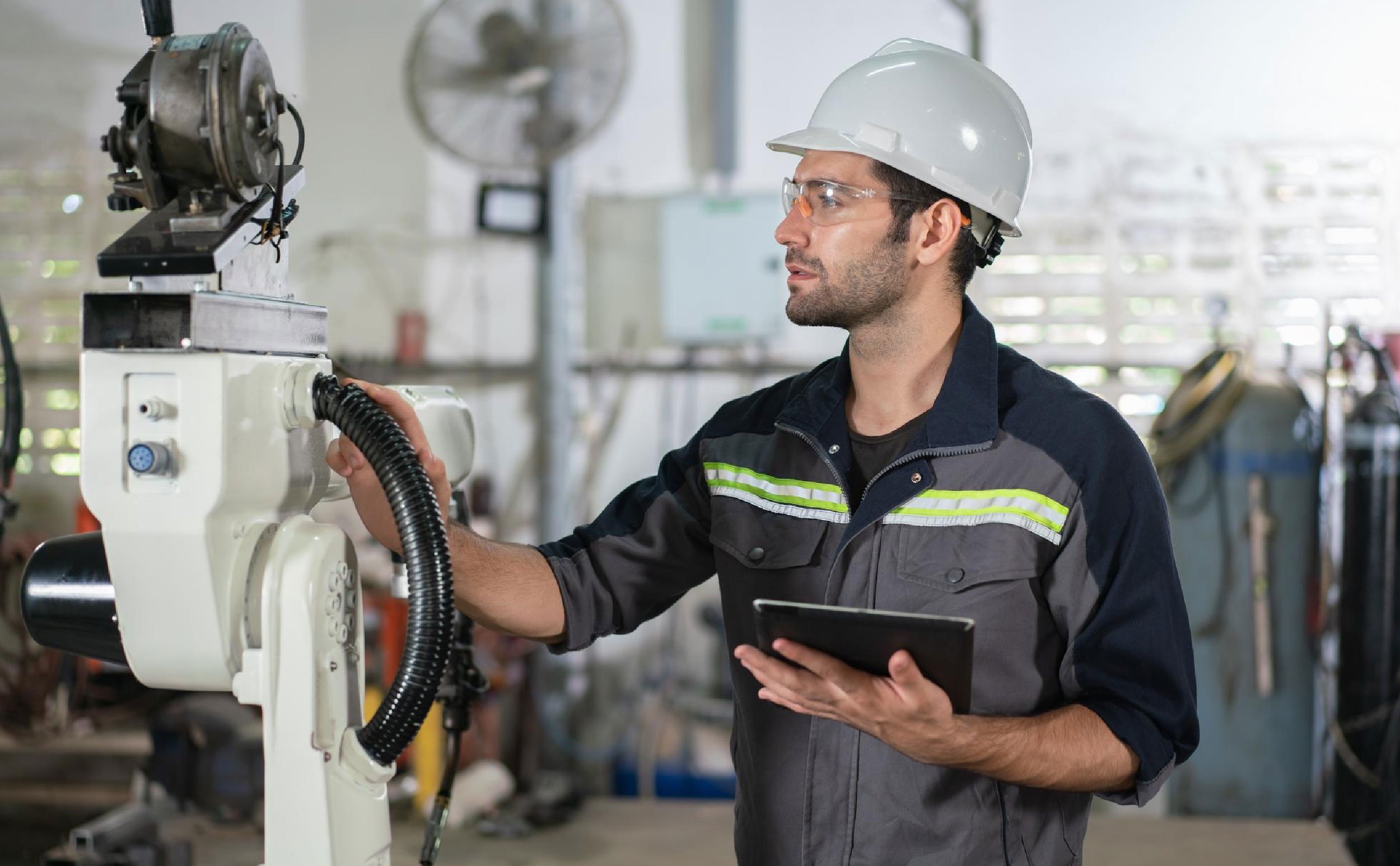sustainable cmms male automation engineer checking inspection control robot arm