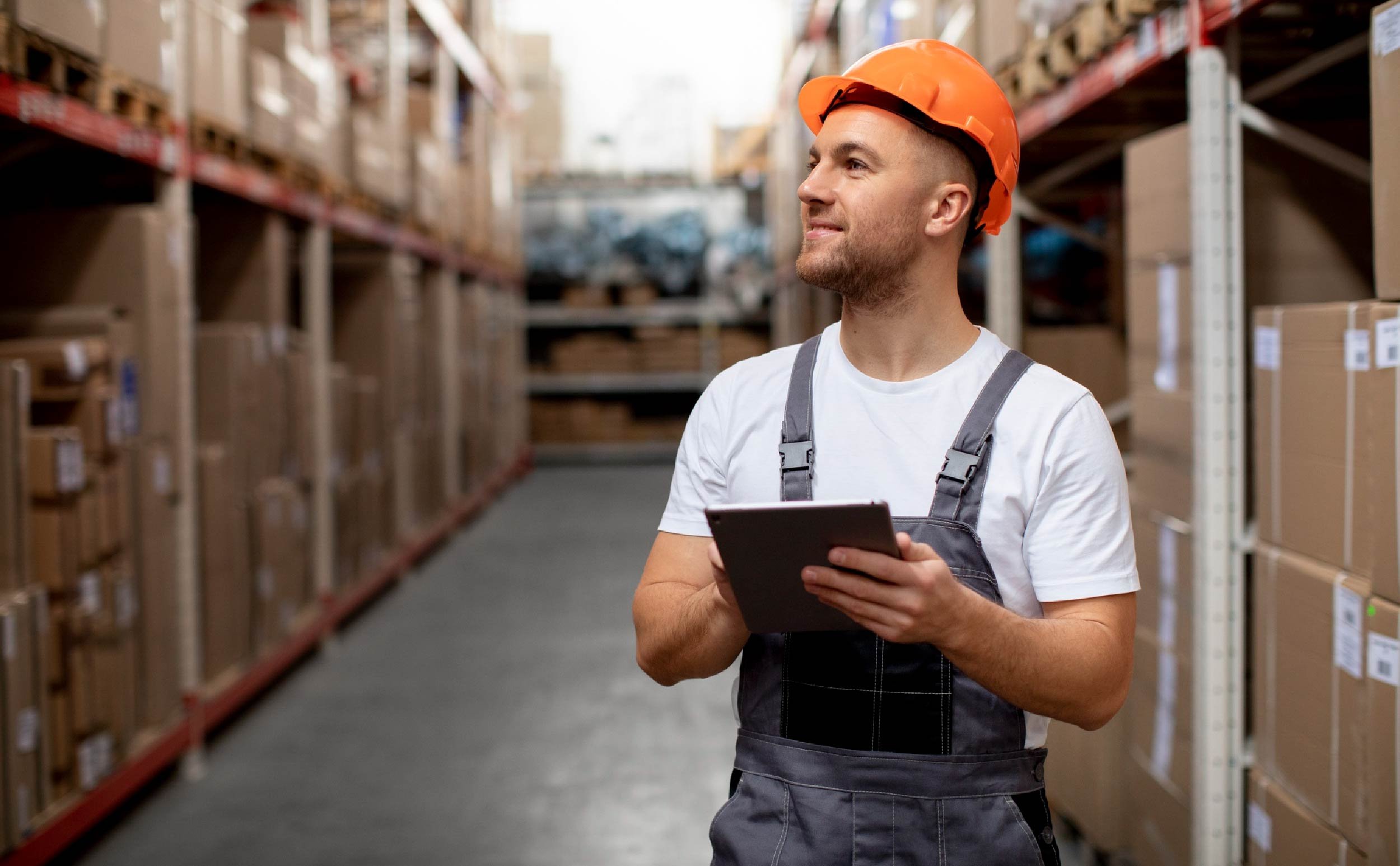 warehouse cmms software man in warehouse holding tablet