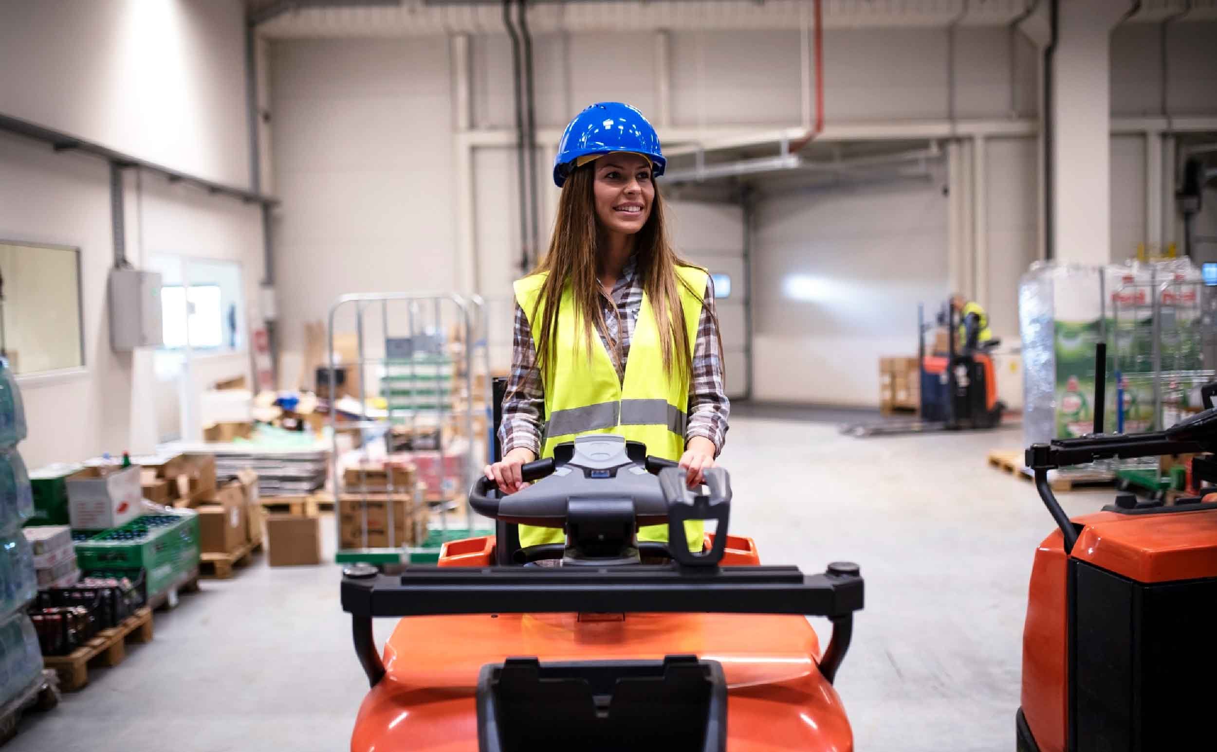 woman warehouse worker with hardhat reflective safety equipment driving forklift machine forklift maintenance checklist