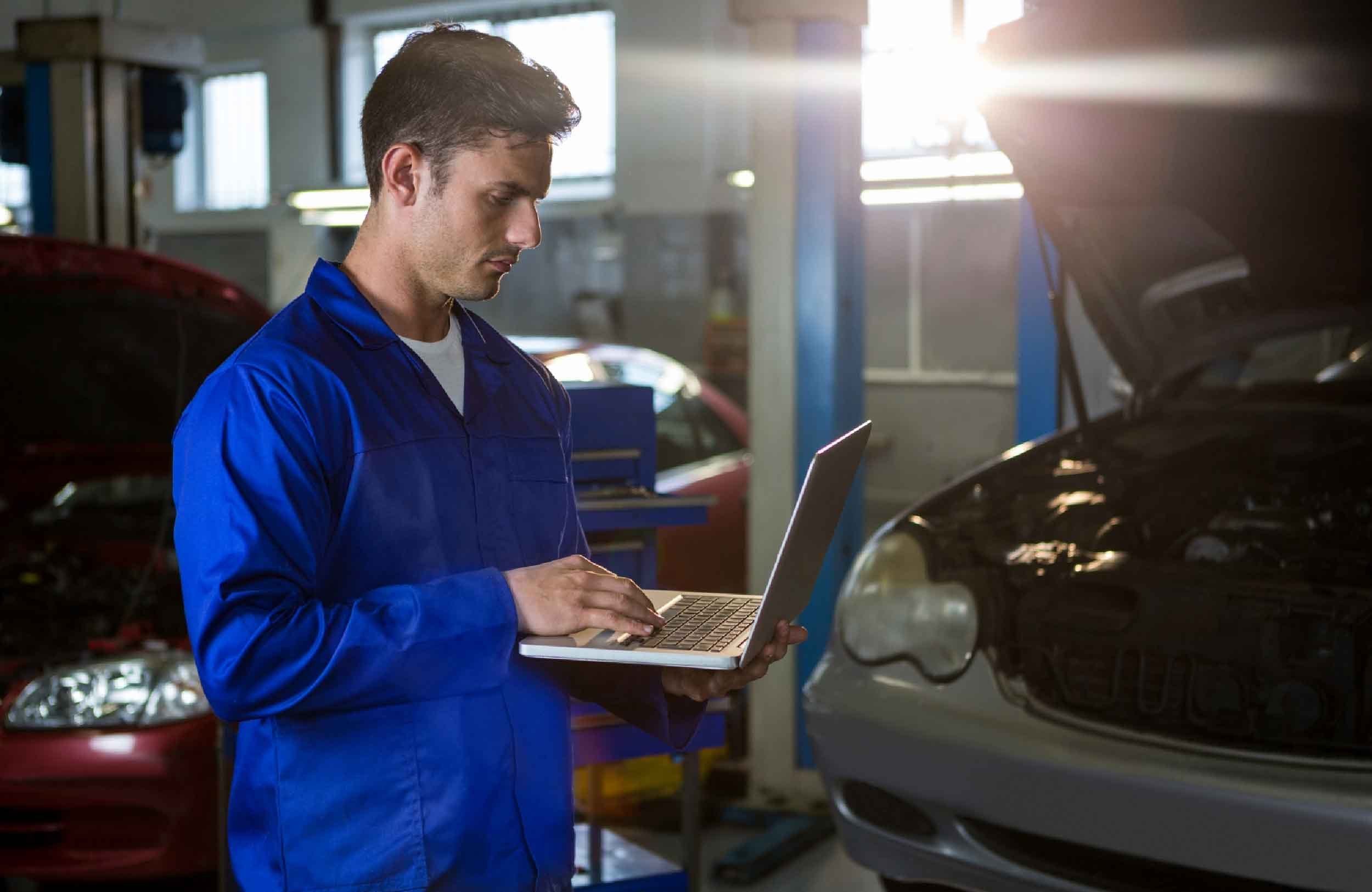 work order software mechanical engineer with laptop