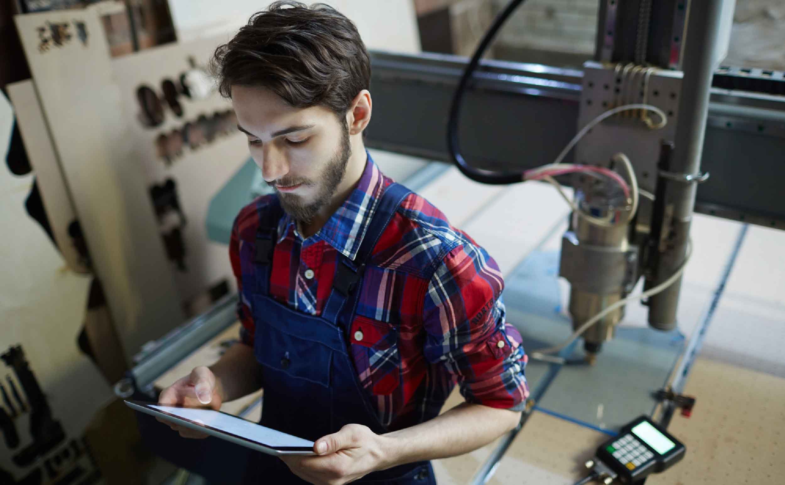 worker with tablet equipment maintenance log